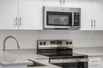Kitchen with refrigerator, range, dishwasher, and garbage disposal